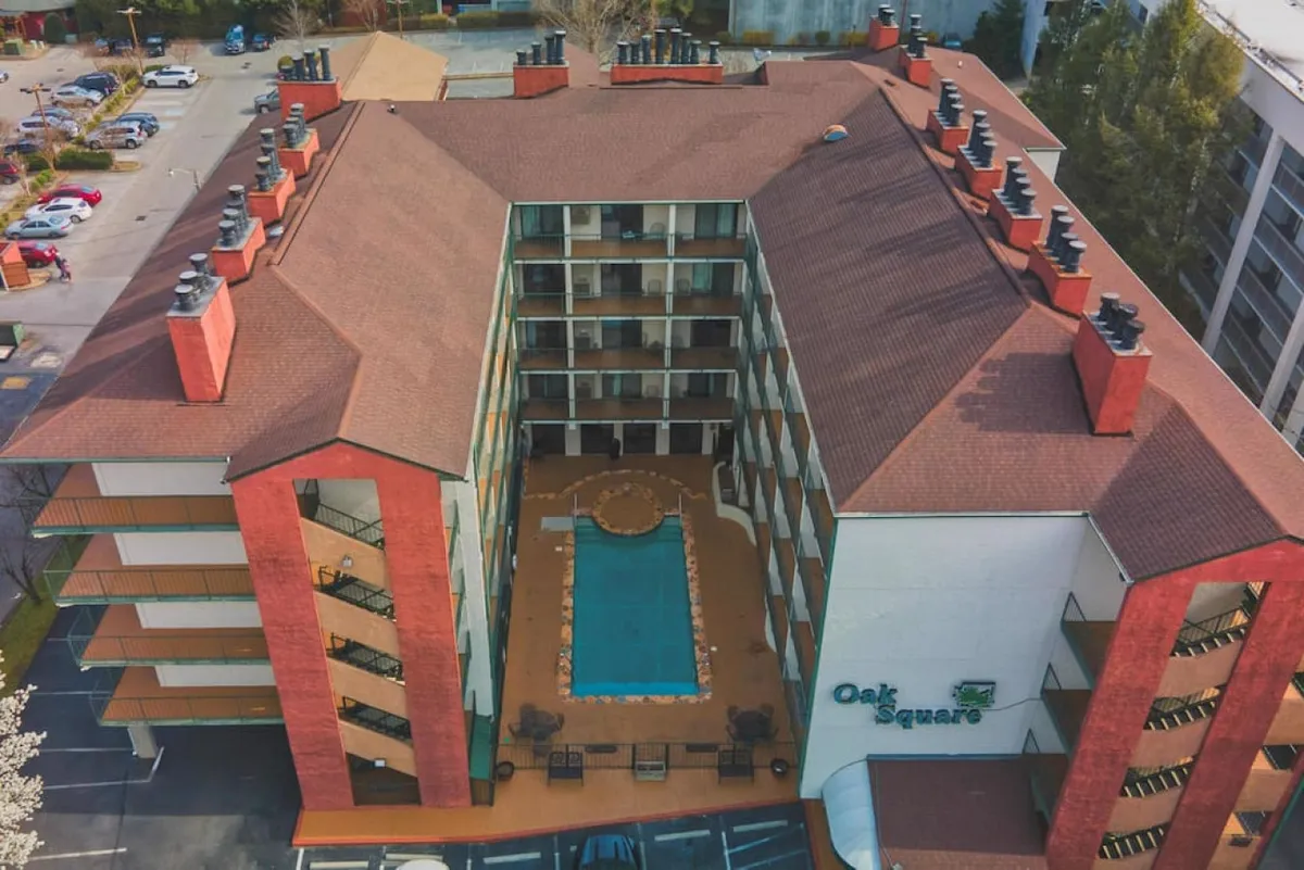This exterior image spotlights an inviting swimming pool surrounded by outdoor seating and the architectural lines of the building. The pool area is primed for socializing, swimming, and unwinding after a day out, resonating with the section’s points about relaxing together and enjoying shared amenities.